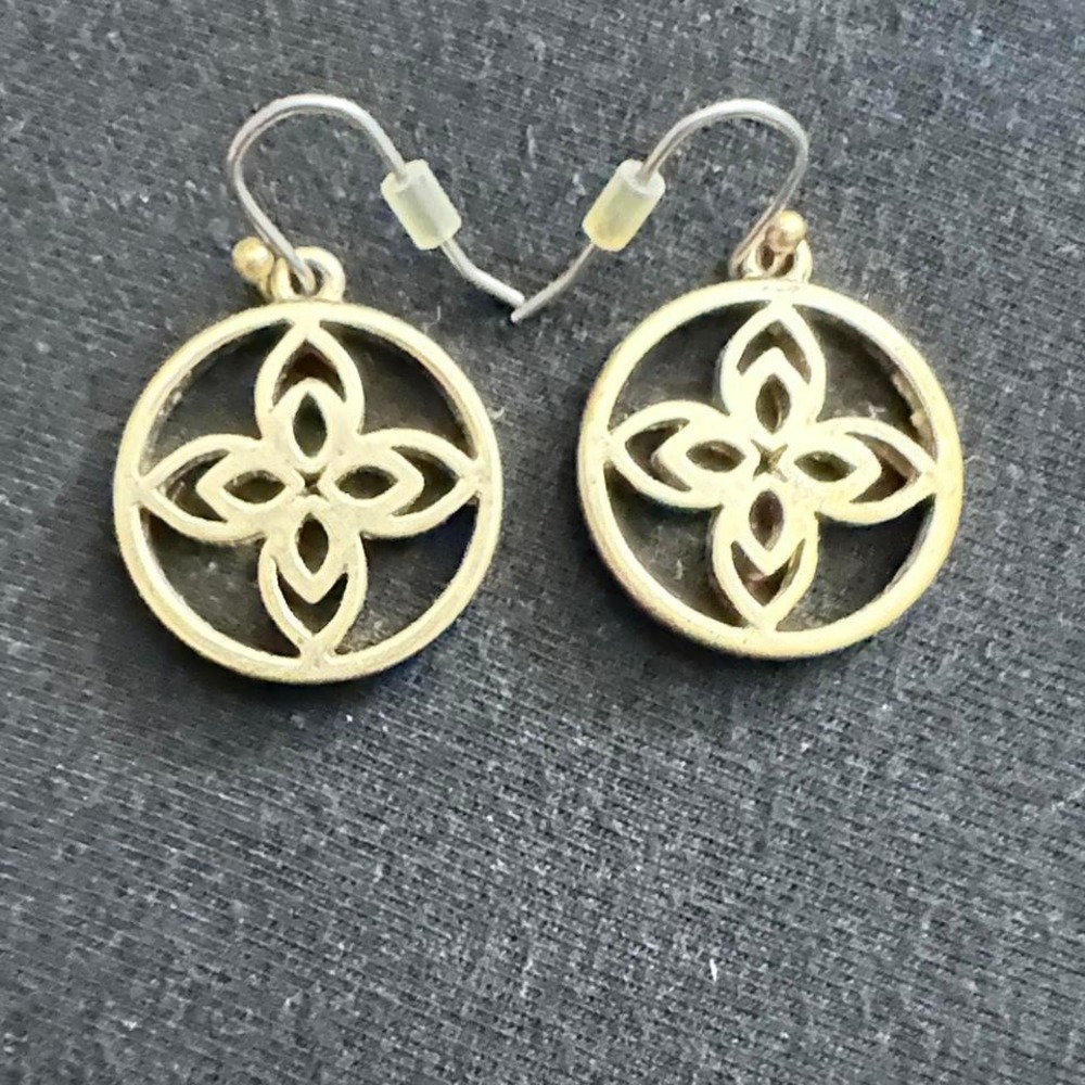 Gold tone earrings with a unique, edgy design